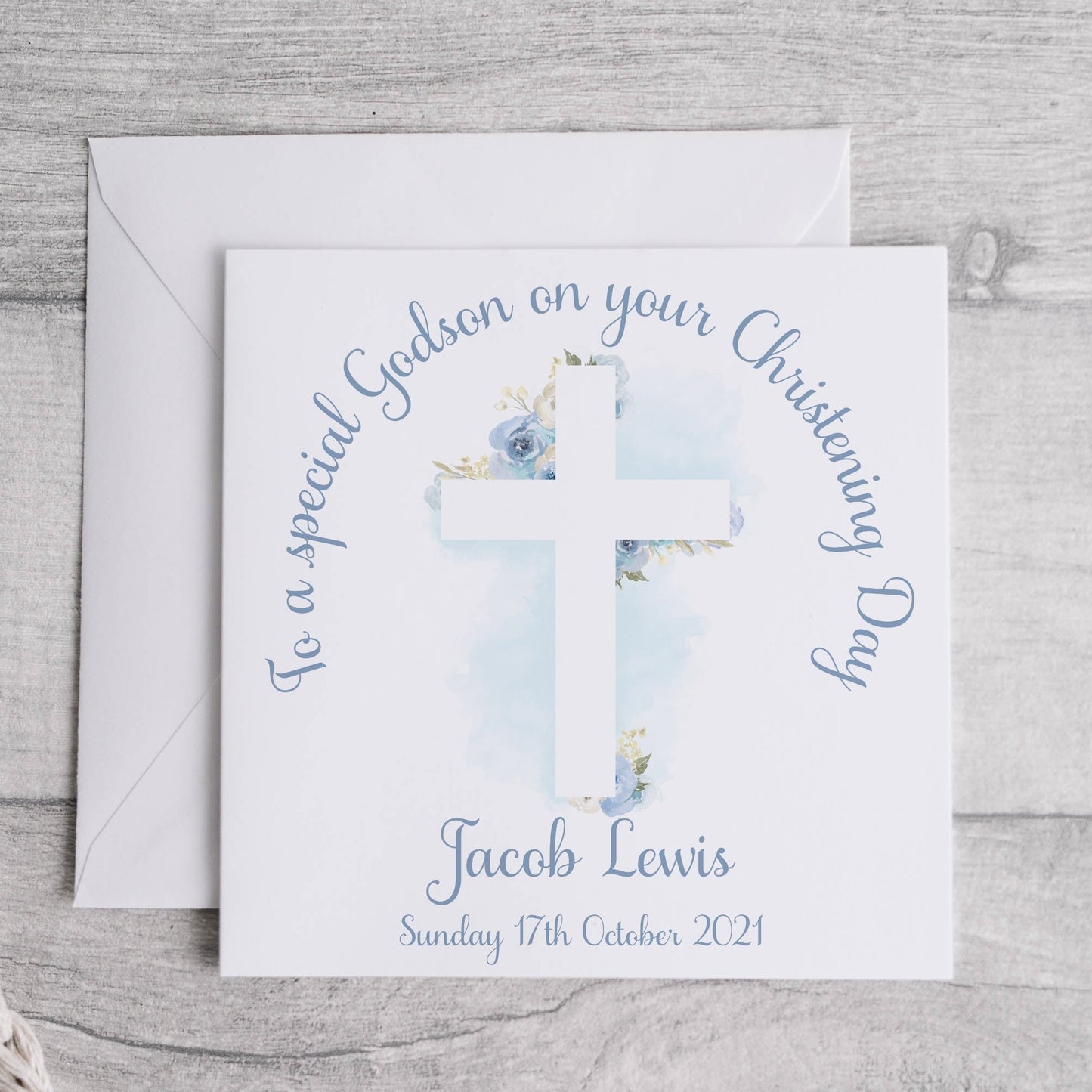 Personalised godson christening card with an image of a floral cross and text.