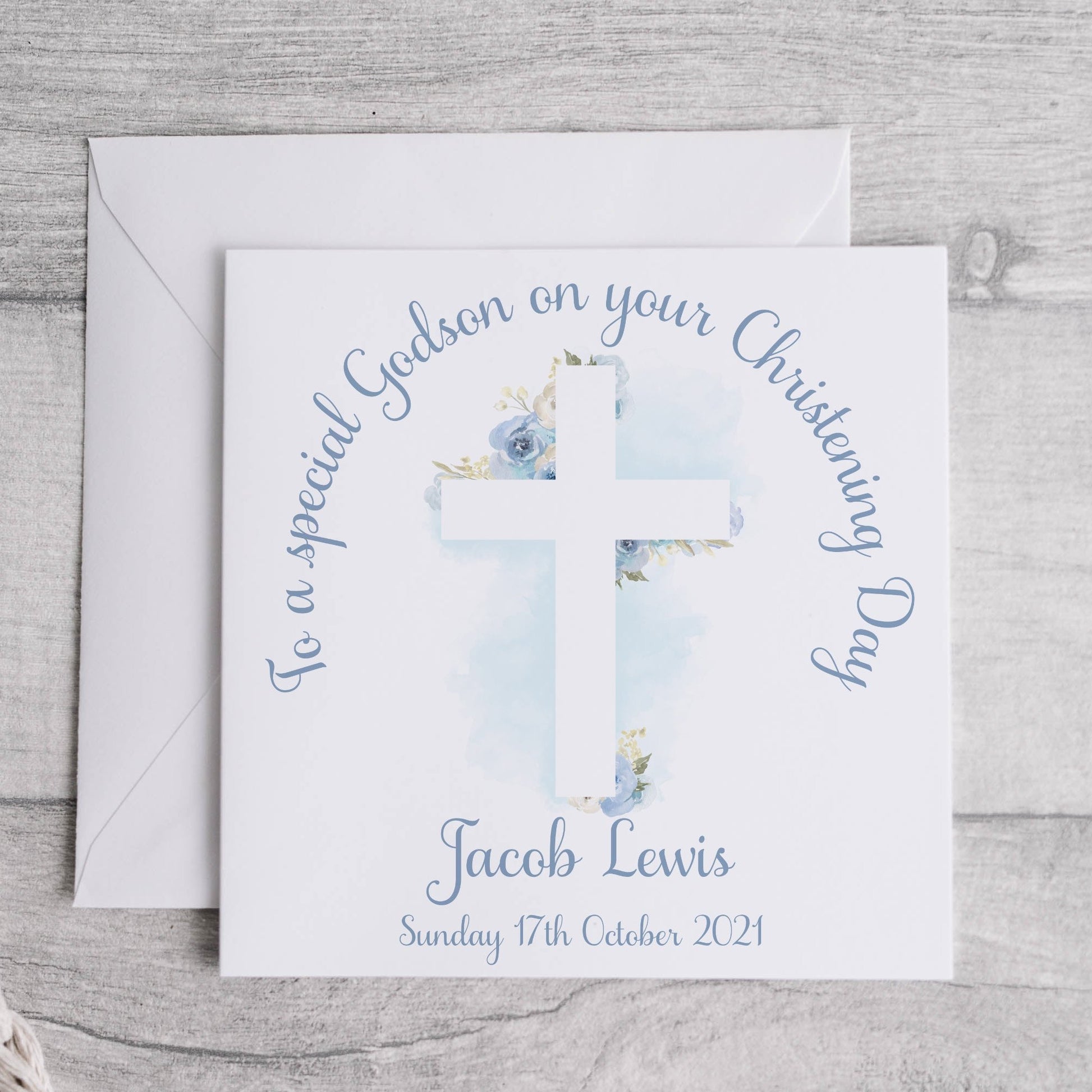 Personalised godson christening card with an image of a floral cross and text.