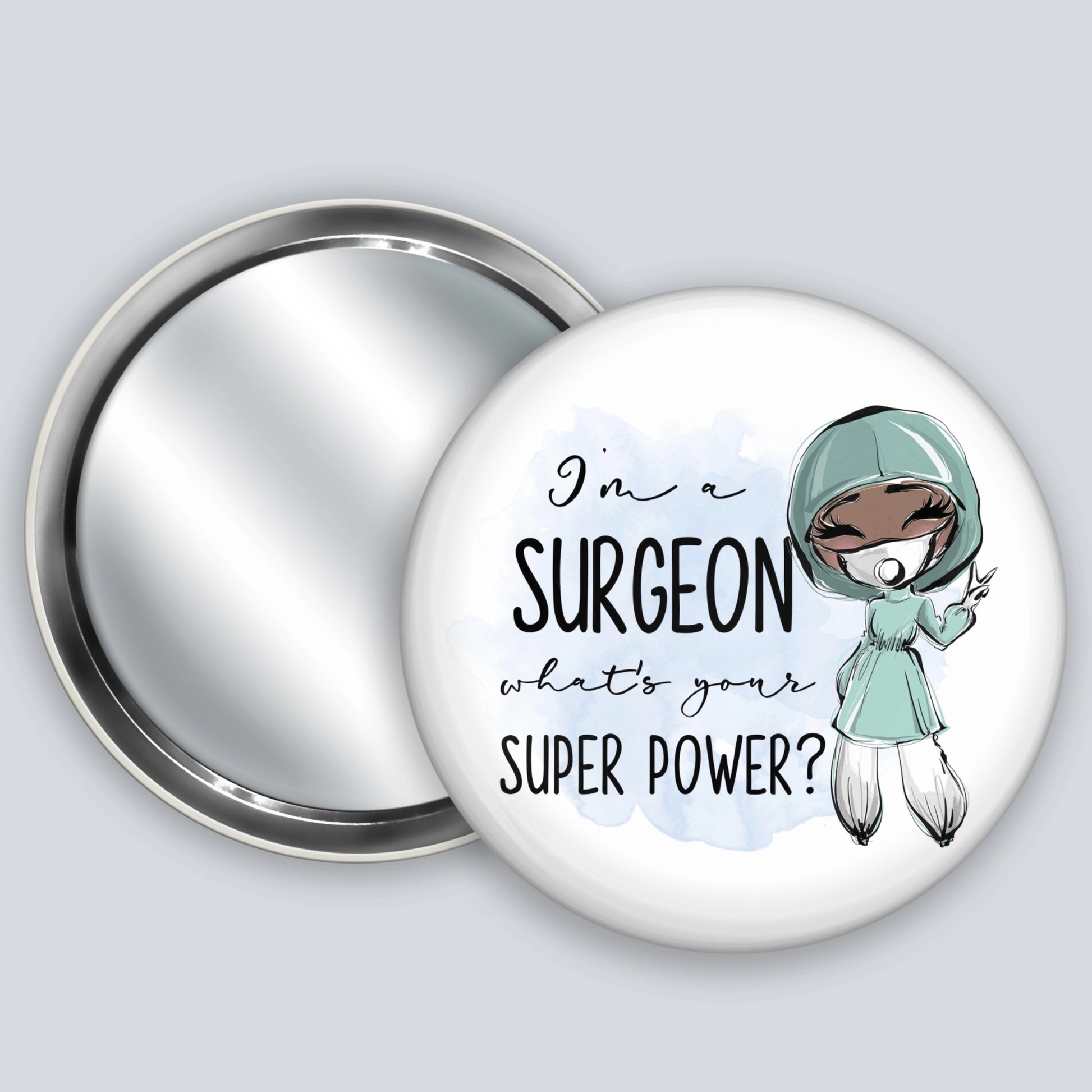 Handheld badge mirror featuring a dark skinned medic and the words I'm a surgeon what's your super power?