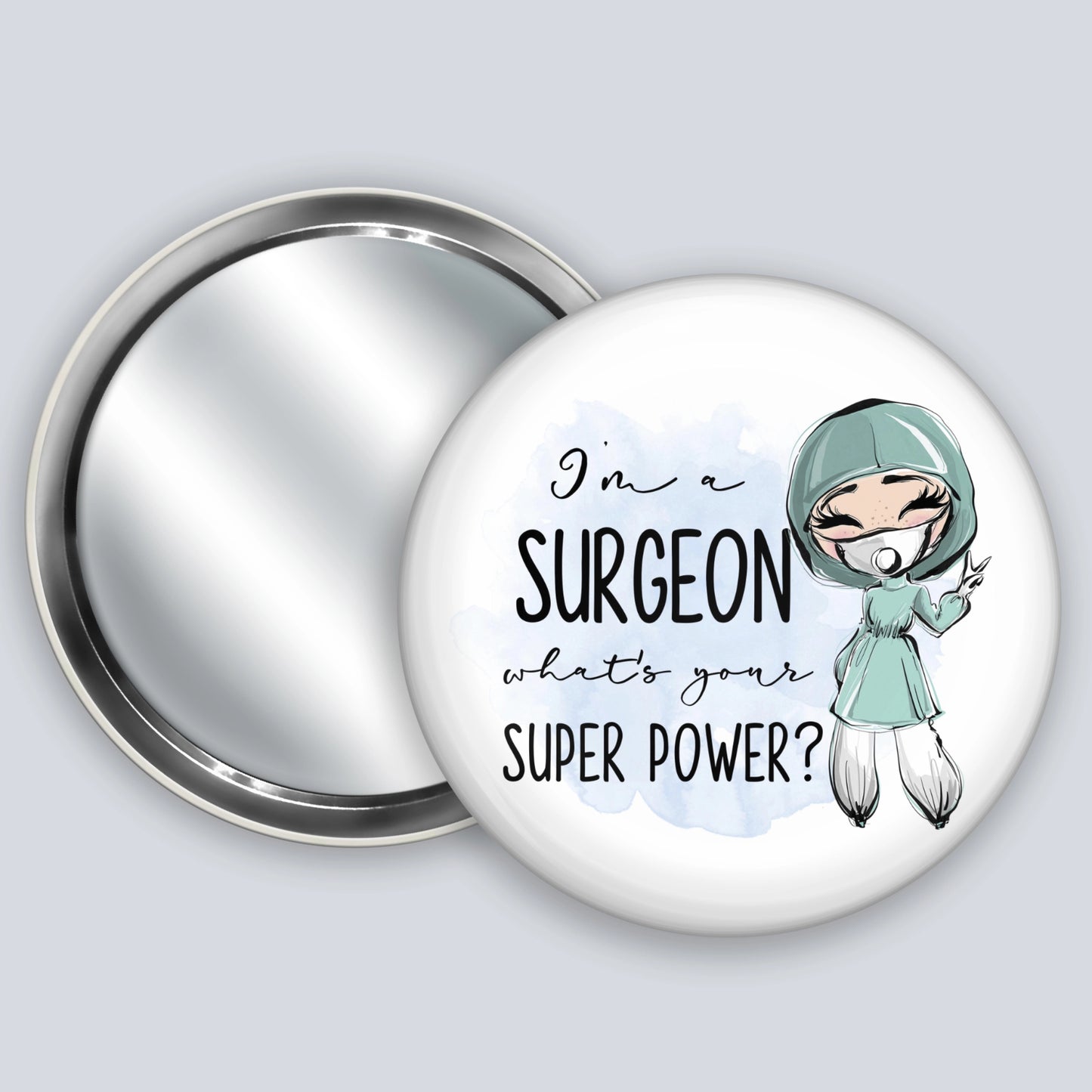 Handheld badge mirror featuring a fair skinned medic and the words I'm a surgeon what's your super power?