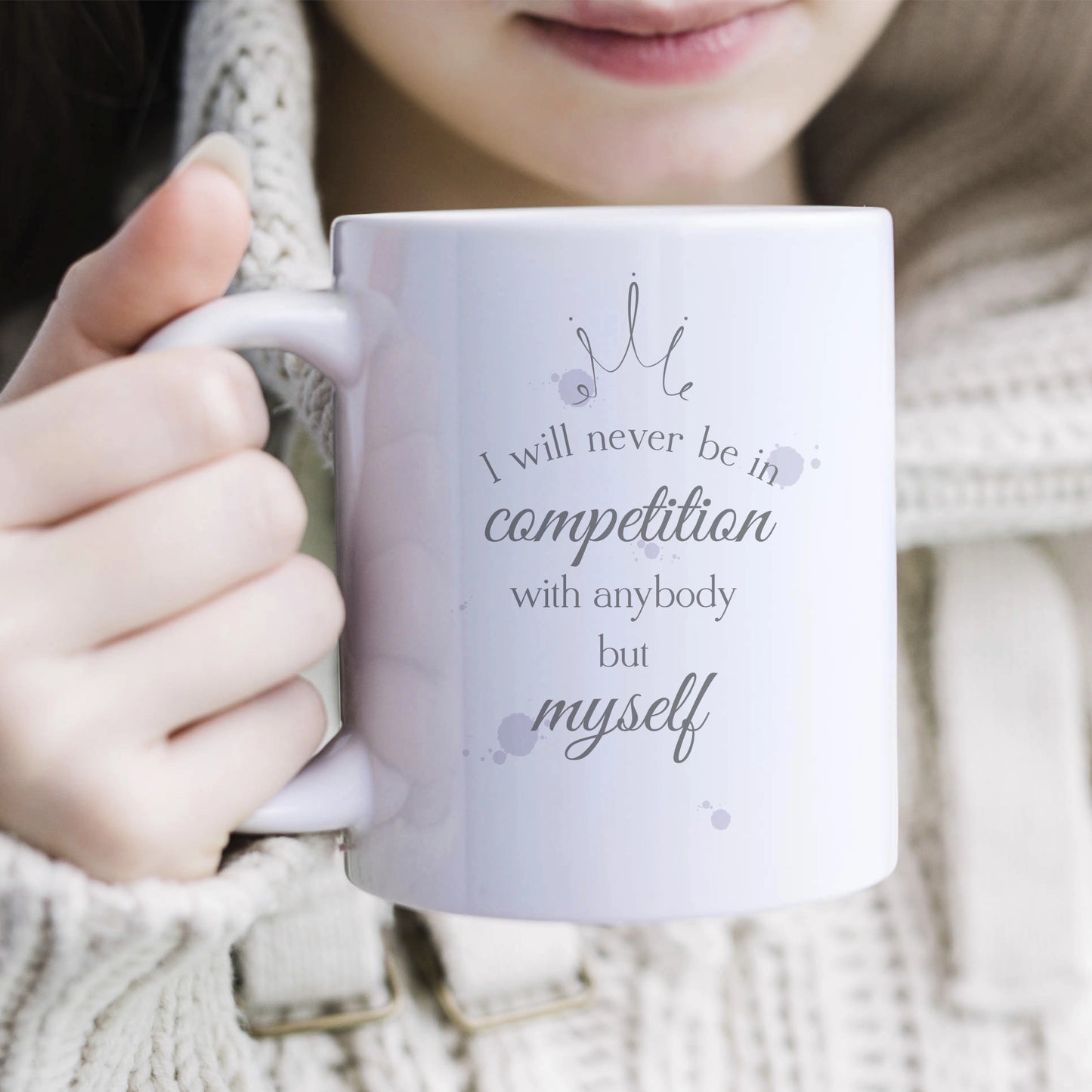 Ceramic mug featuring a sketch crown and the words 'I will never be in competition with anybody but myself' with a few splodges of colour in lilac