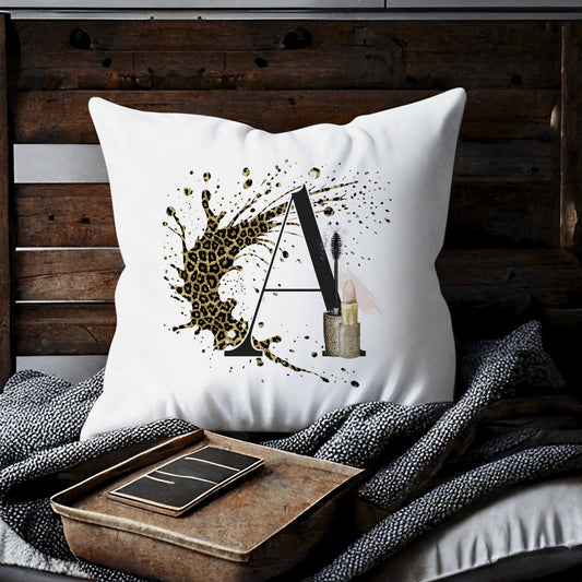 Cushion with a leopard print background splash and an initial letter A with a lipstick and mascara