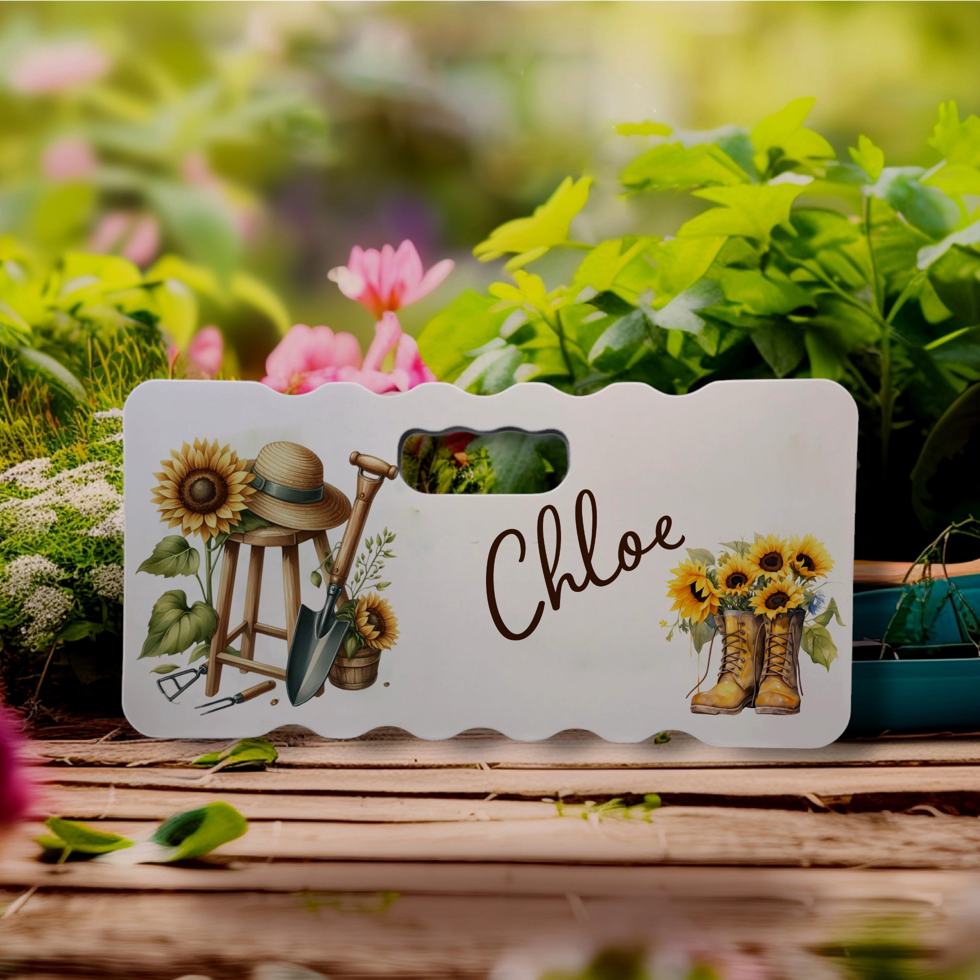 Personalised Kneeling Pad with a picture of gardening equipment and wellies with sunflowers and the name Chloe 