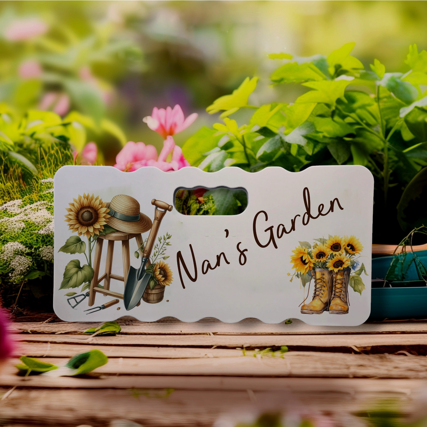 Personalised Kneeling Pad with a picture of gardening equipment and wellies with sunflowers and the name Nan's Garden