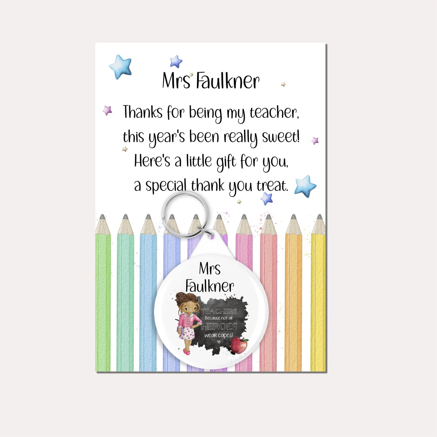 Personalised badge keyring  featuring a female teacher and an apple with the quote 'Teachers because not all heroes wear capes!' on a backing card with a pencil design and a poem.