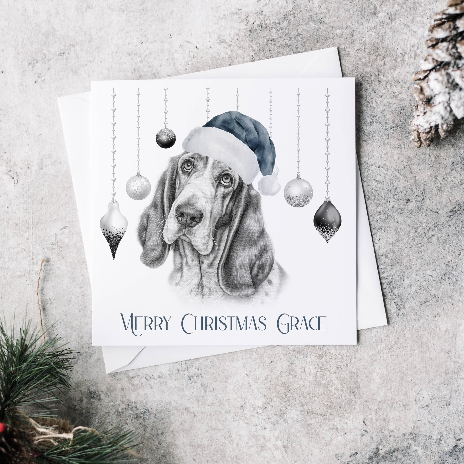 Personalised Christmas card featuring baubles and a  Basset Hound wearing a Blue Christmas hat.