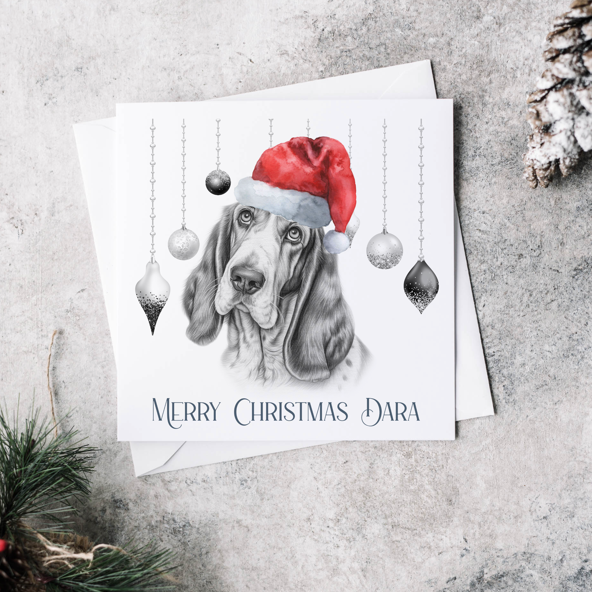 Personalised Christmas card featuring baubles and a  Basset Hound wearing a red Christmas hat.