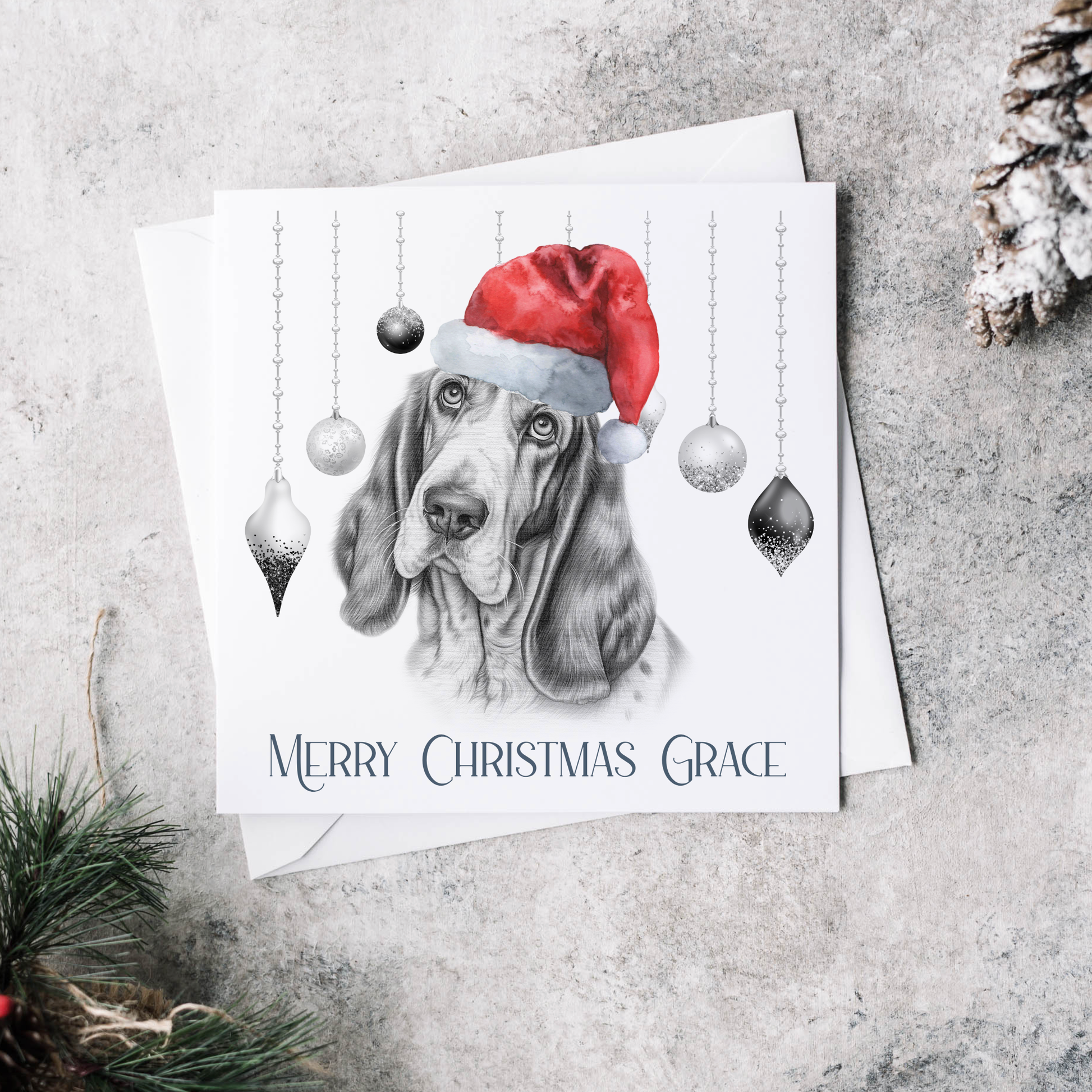 Personalised Christmas card featuring baubles and a  Basset Hound wearing a red Christmas hat.