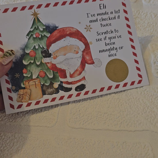 A ideo of a card with an image of Santa Claus next to a Christmas tree with the text 'I've made a list and checked it twice. Scratch to see if you've been naughty or nice' This is personalised and has a gold scratch off sticker