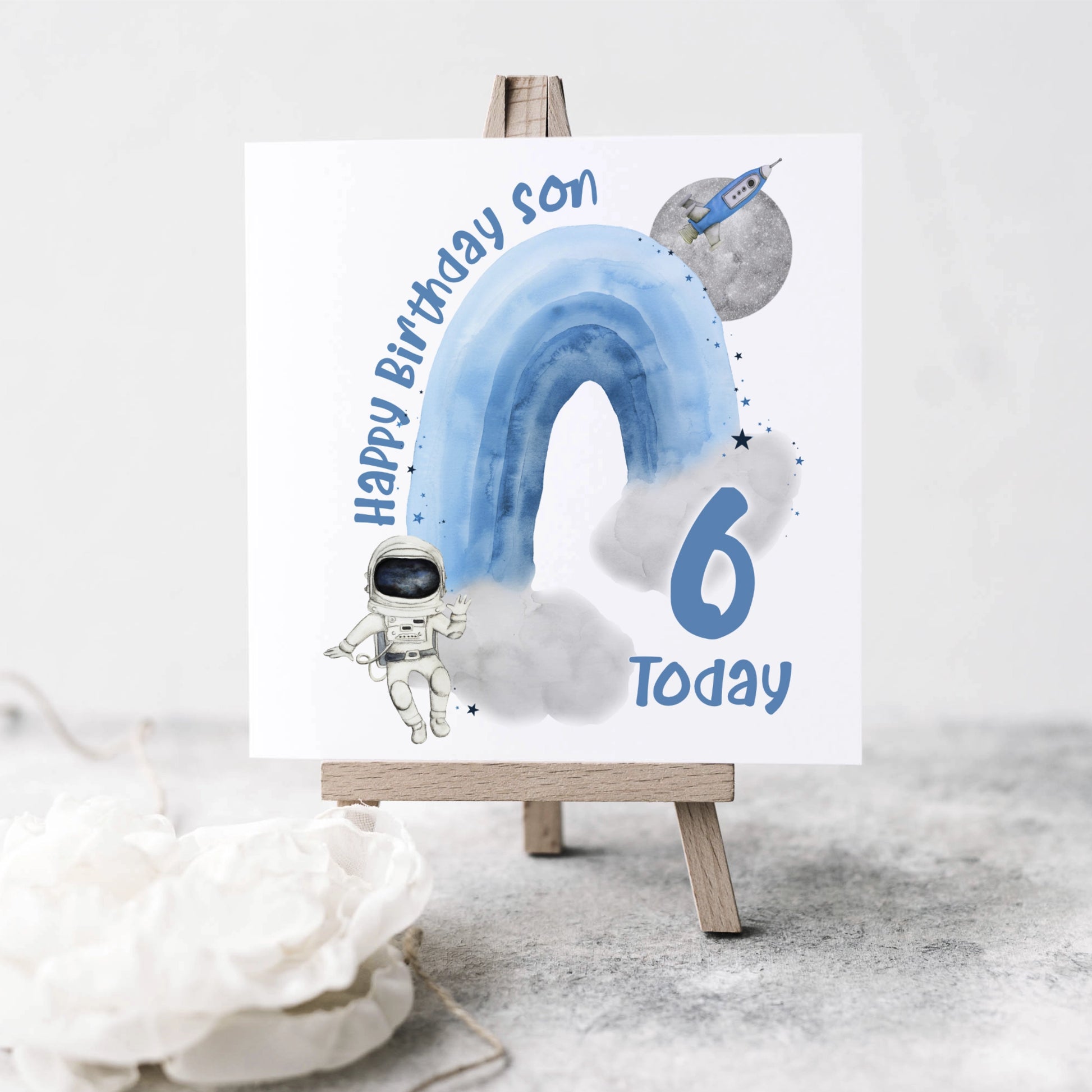 Personalised Birthday card featuring an astronaut, rocket, planet and a rainbow with a name and age