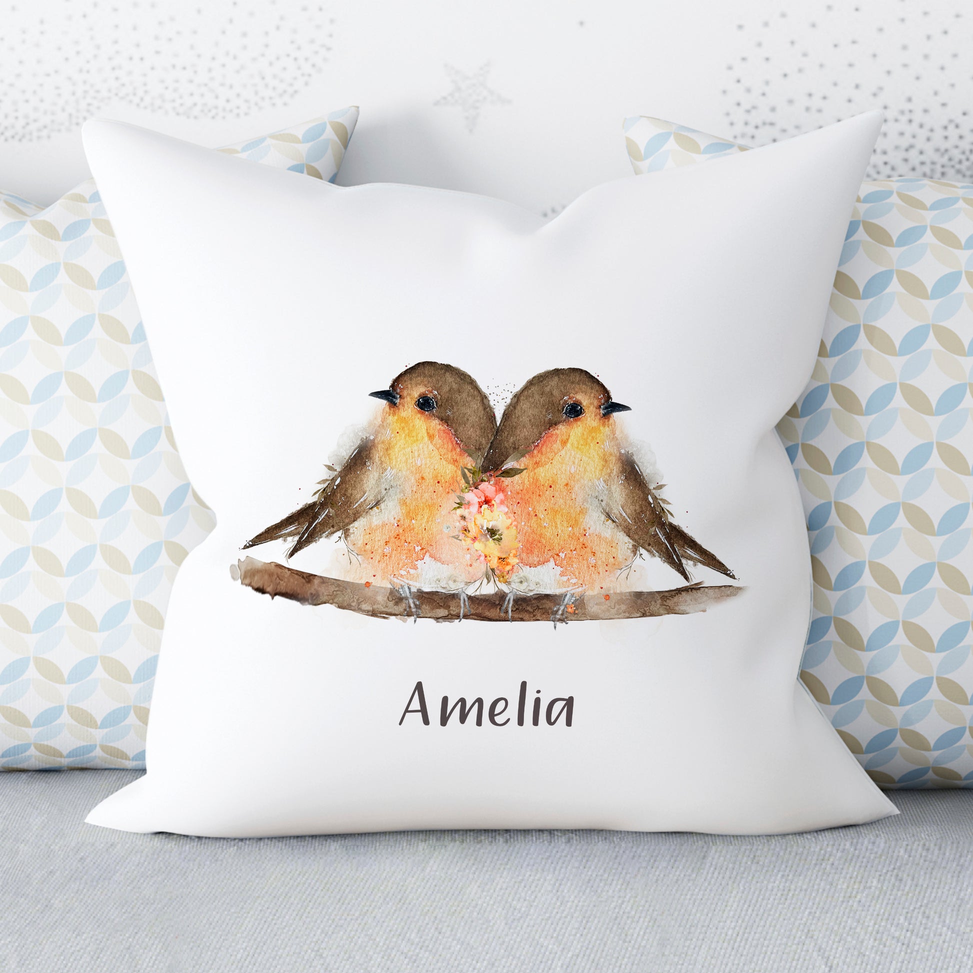 cushion with two robins siting on a branch and personalised