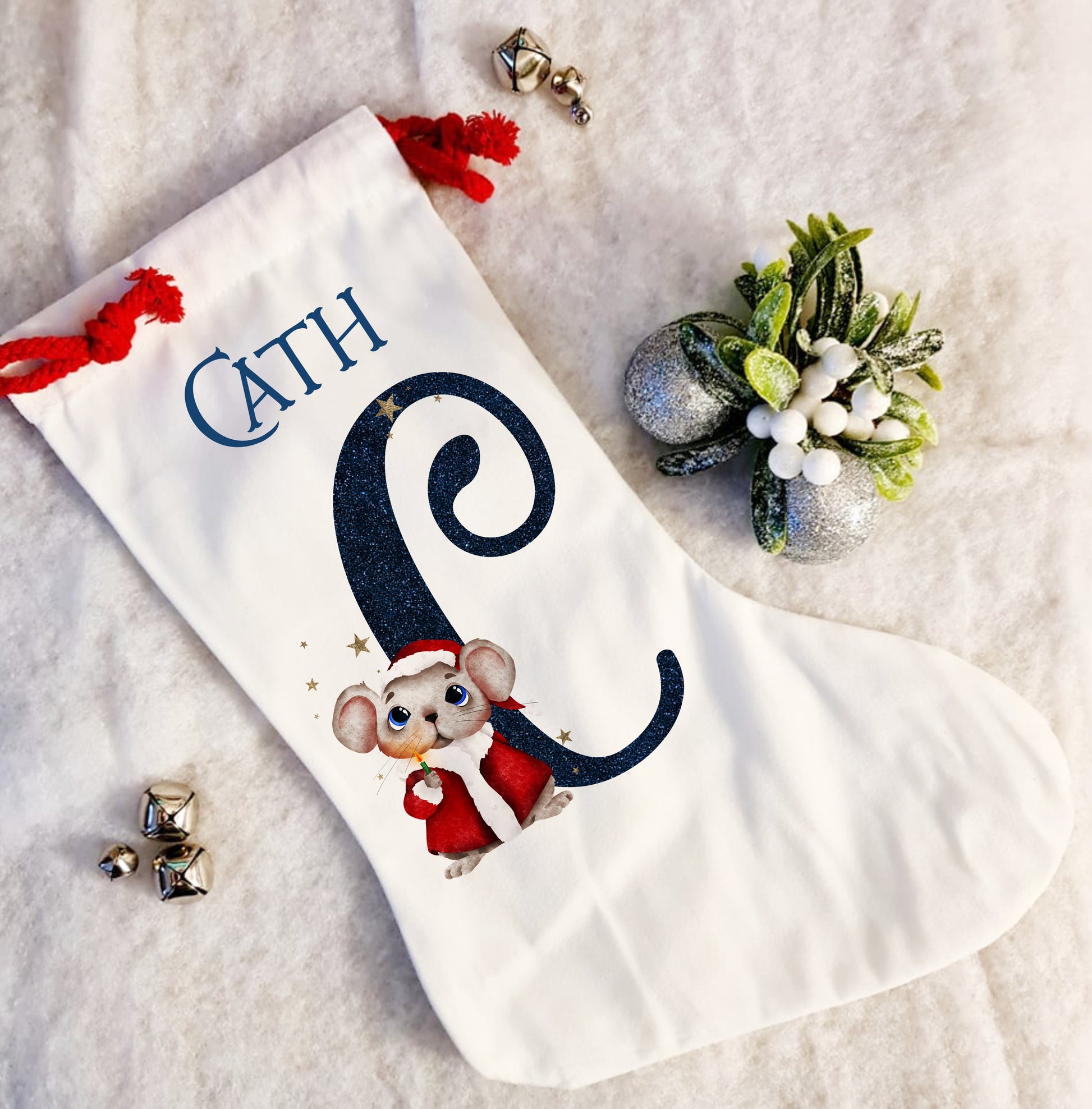 Personalised white Christmas stocking with a red rope tie and a Christmas mouse alphabet in red and navy