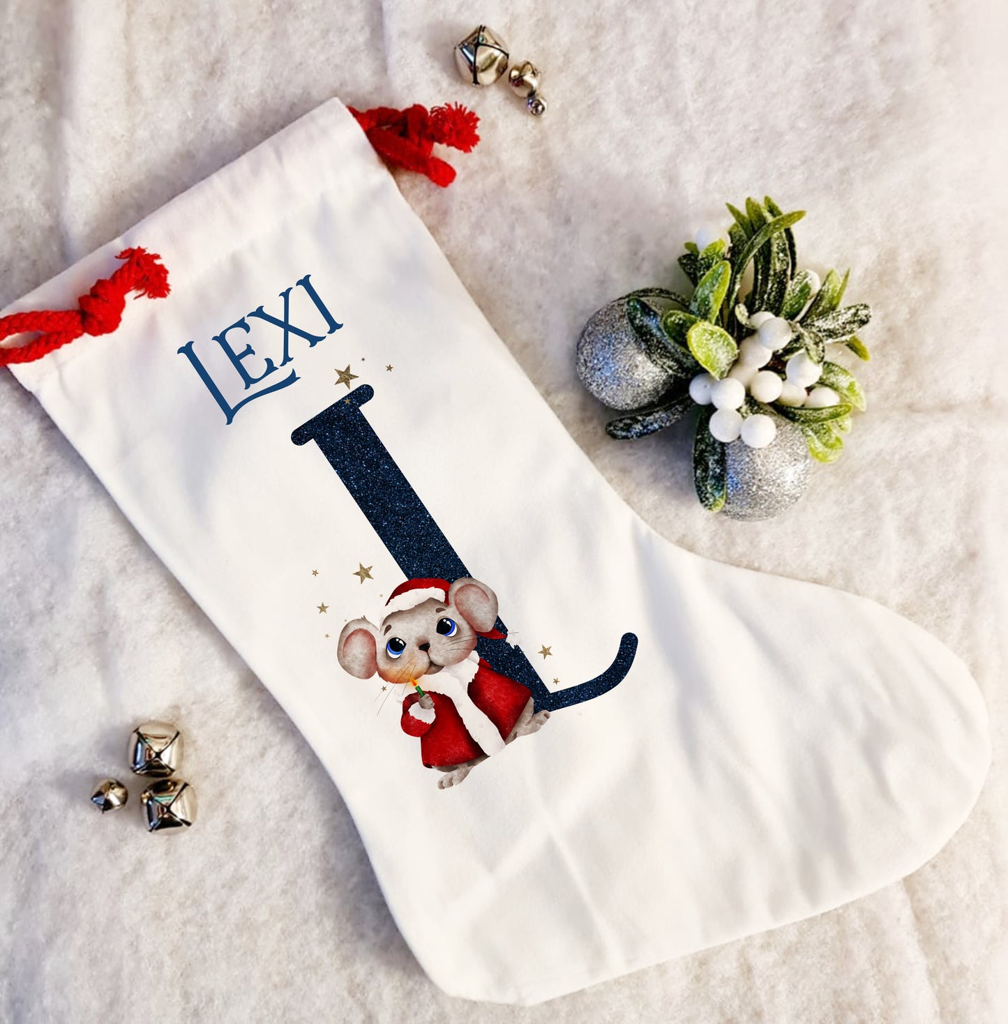 Personalised white Christmas stocking with a red rope tie and a Christmas mouse alphabet in red and navy
