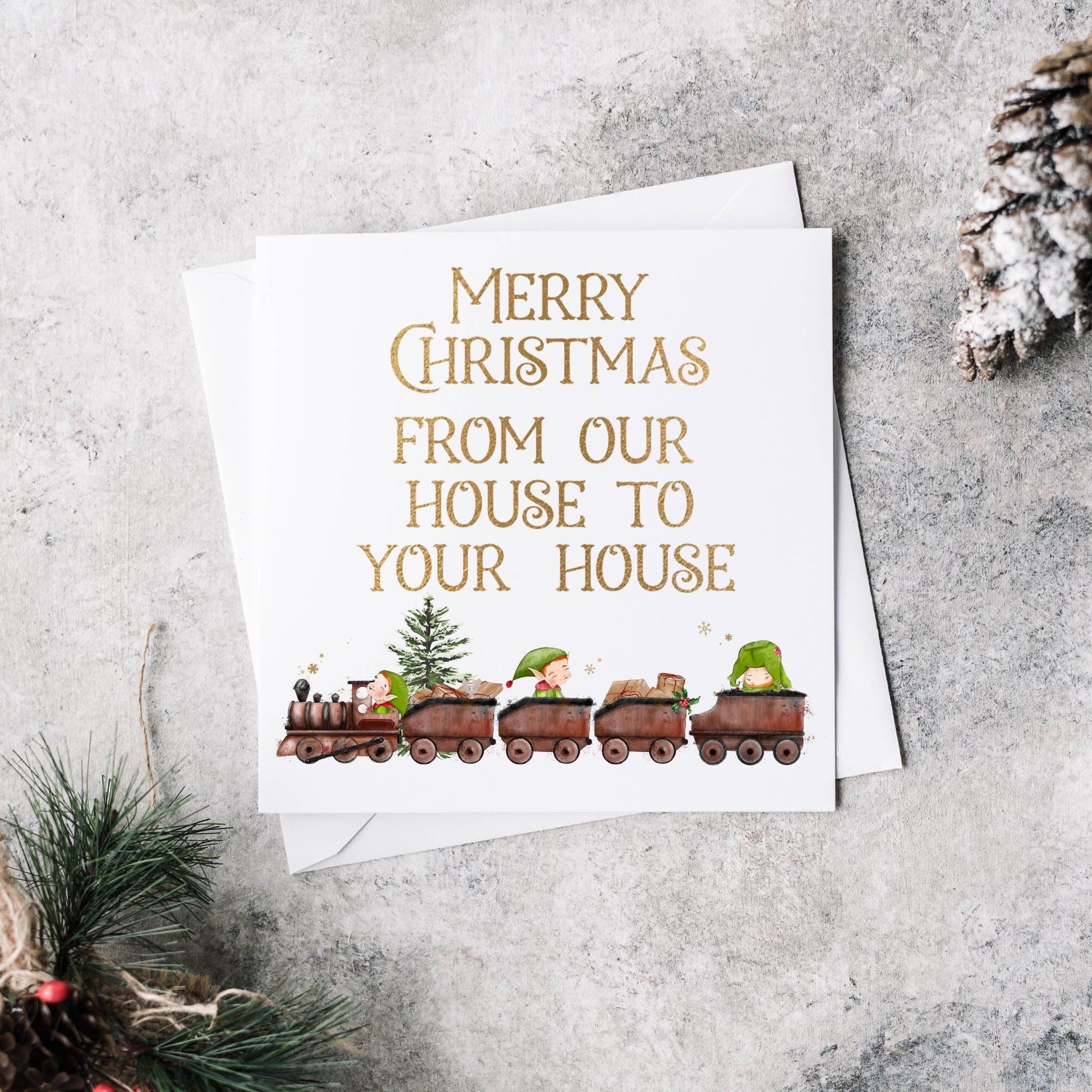 Christmas card with an elf train design and text reading 'Merry Christmas from our house to your house'