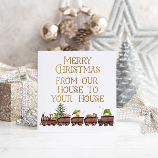 Christmas card with an elf train design and text reading 'Merry Christmas from our house to your house'