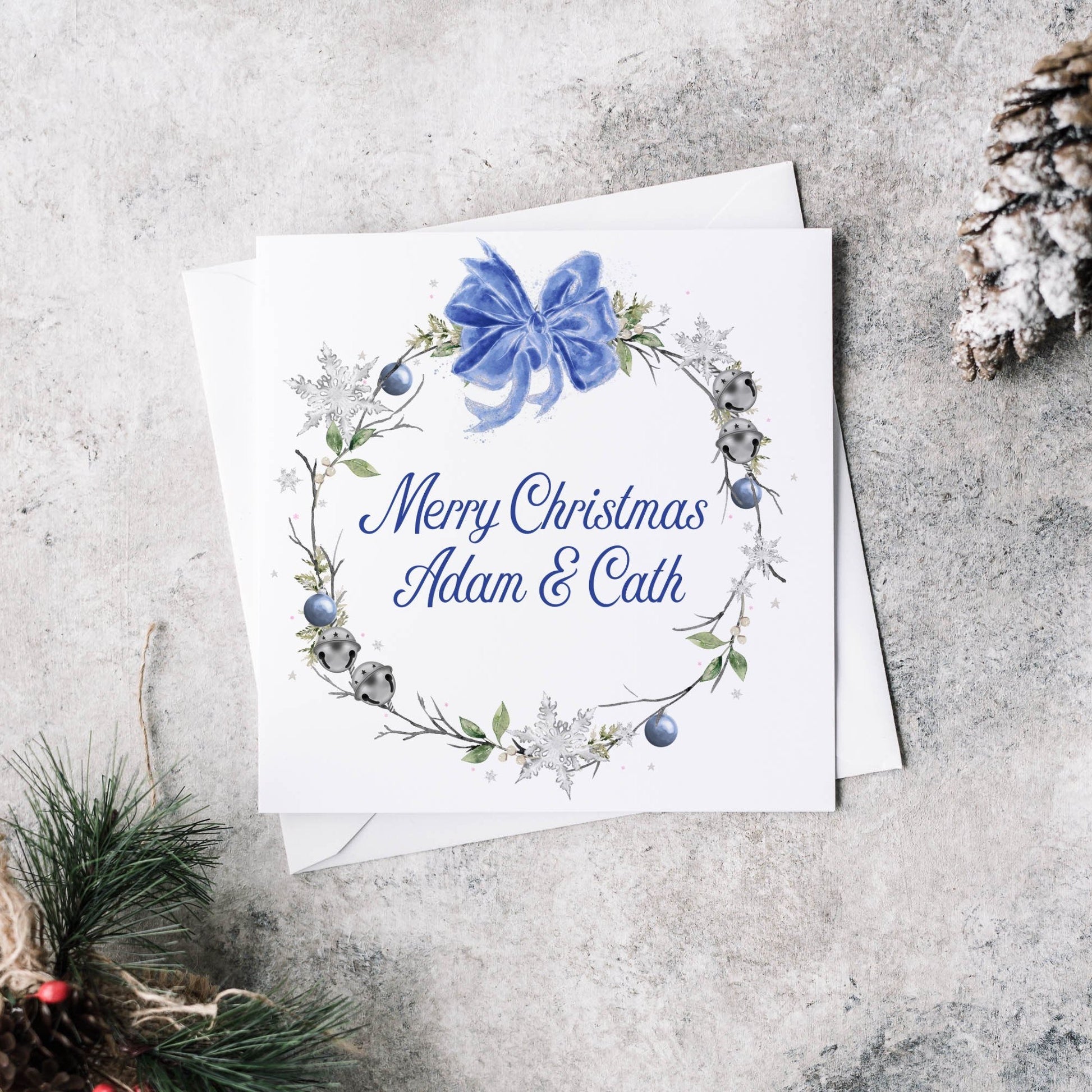 Christmas greeting card featuring a winter blue wreath and personalised text