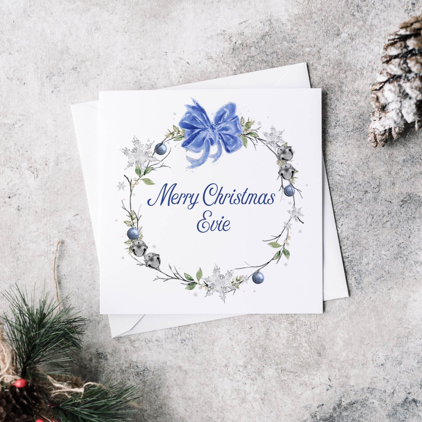 Christmas greeting card featuring a winter blue wreath and personalised text