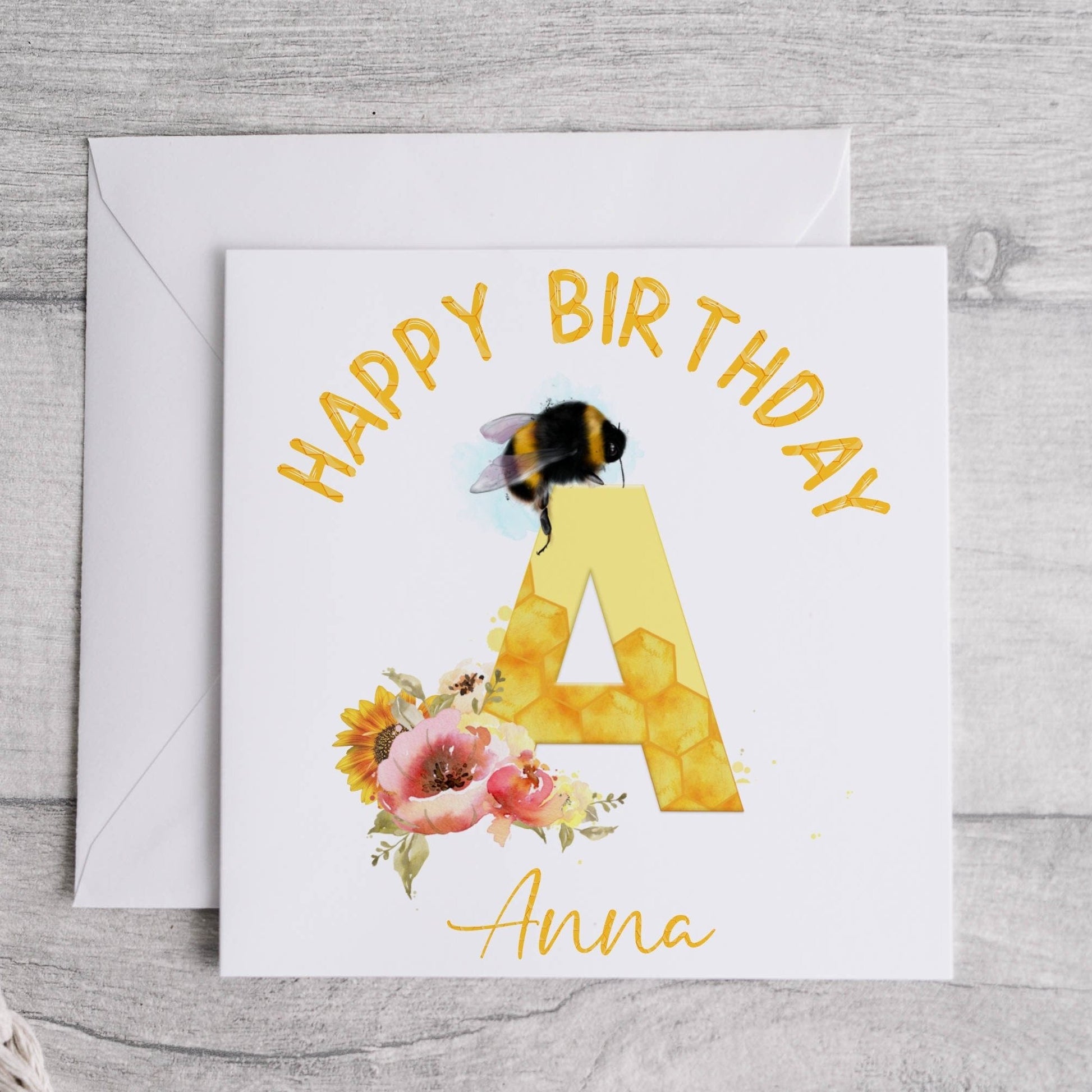 Personalised birthday card with a bumble bee, flowers and the initial letter A