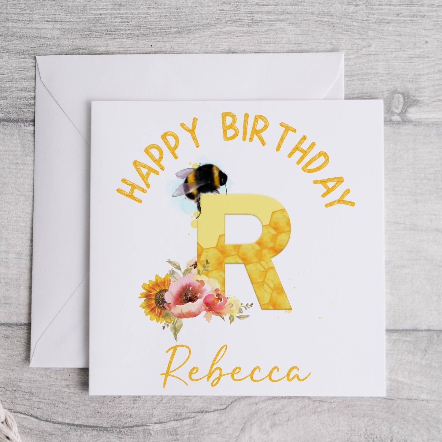 Personalised birthday card with a bumble bee, flowers and the initial letter R