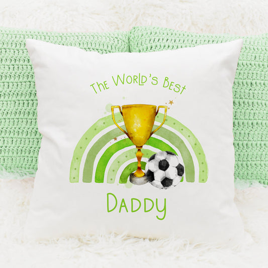 Square cushion featuring a rainbow in green, a trophy and a football. Text reads 'The World's Best' and can be personalised