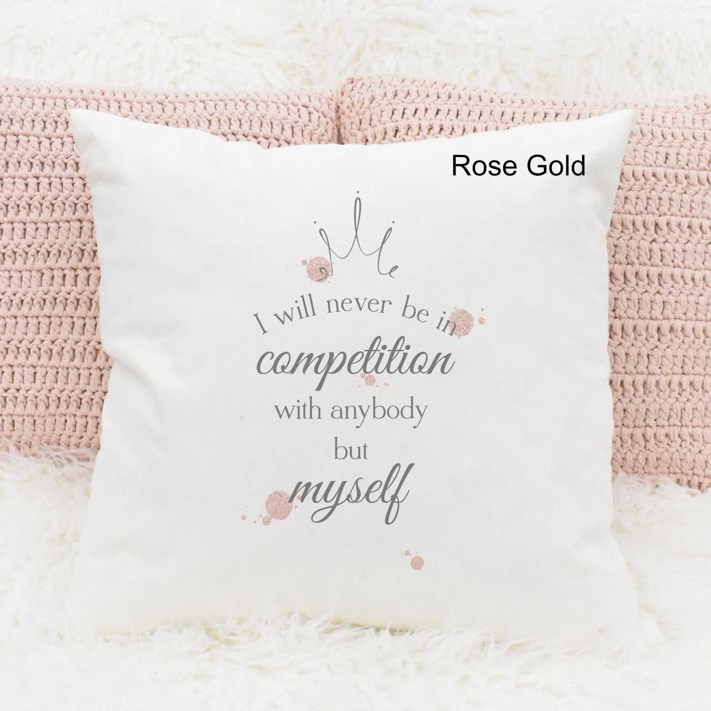 Square cushion featuring rose gold watercolour splodges and a crown with the text 'I will never be in competition with anybody but myself'