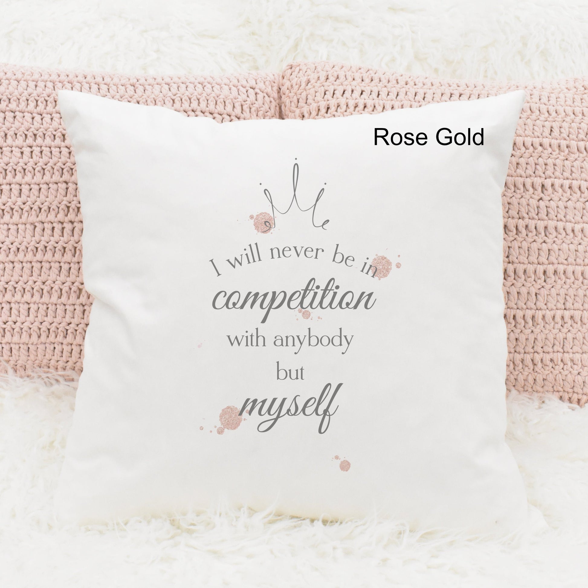 Square cushion featuring rose gold watercolour splodges and a crown with the text 'I will never be in competition with anybody but myself'