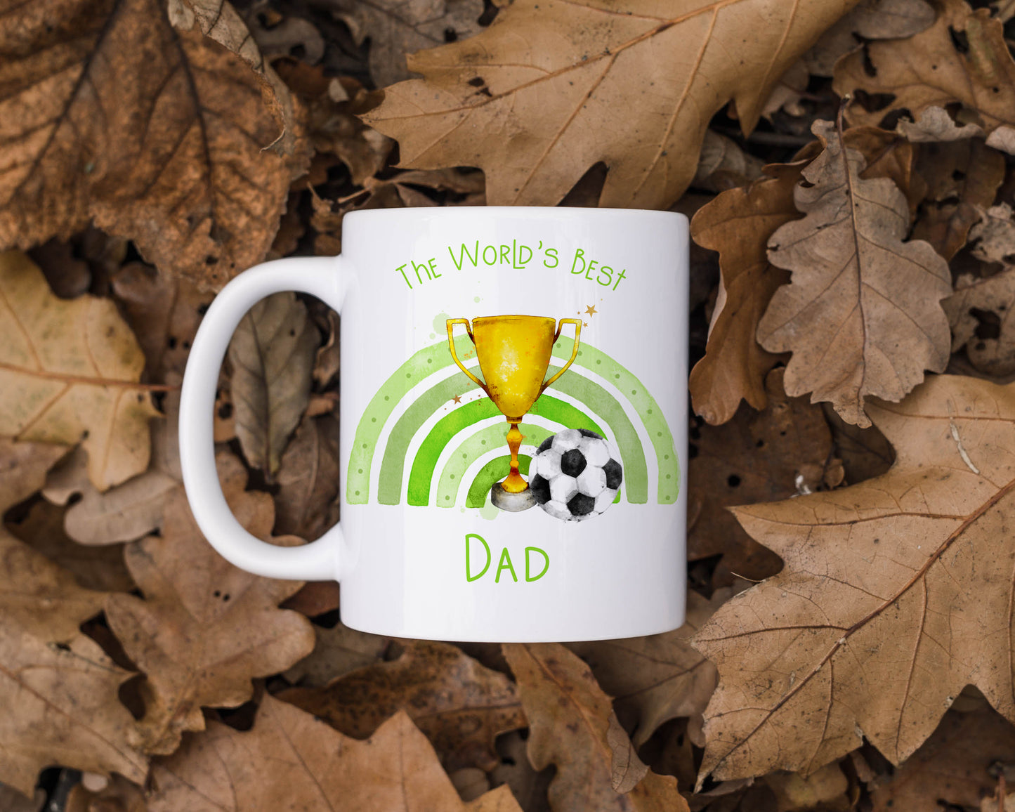 Ceramic mug featuring a trophy, football and green rainbow. The text reads 'The World's best' and can be personalised