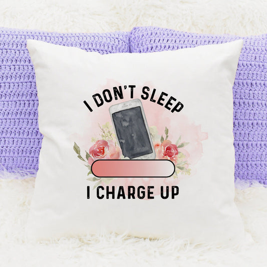 Cushion with a mobile phone image and flowers and text that reads 'I don't sleep, I charge up'