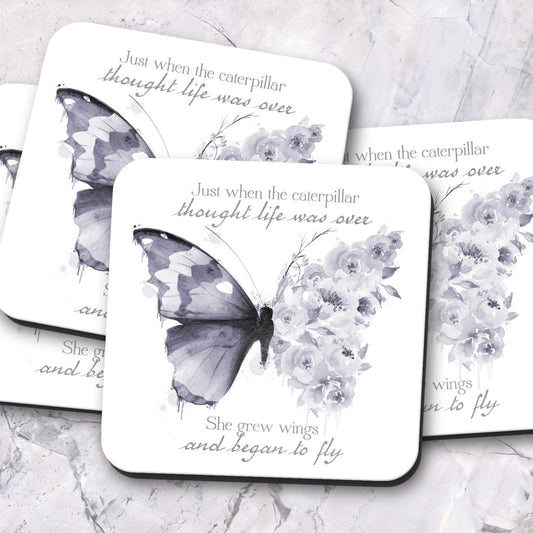 Dark purple floral butterfly hardboard coasters with text reading 'Just when the caterpillar thought life was over, she grew wings and began to fly'