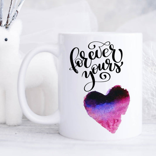 Ceramic mug with a purple and pink love heart and the text 'forever yours' printed on it.