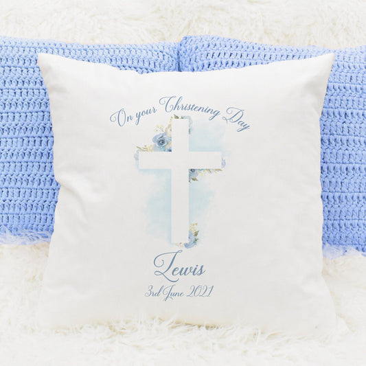 Christening cushion gift featuring a floral cross in blue and personalised text