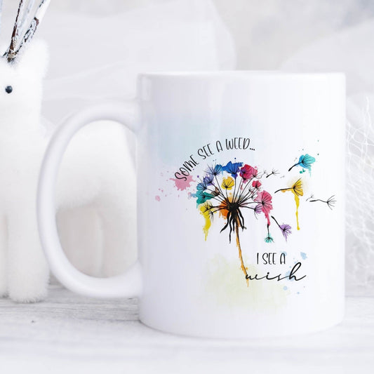 Ceramic mug featuring a bright dandelion design with text that reads 'Some see a weed, I see a wish'