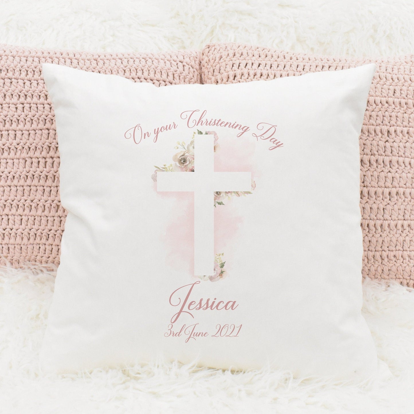 Christening cushion gift featuring a floral cross in pink and personalised text