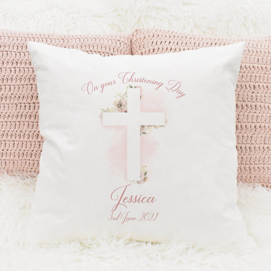 Christening cushion gift featuring a floral cross in pink and personalised text