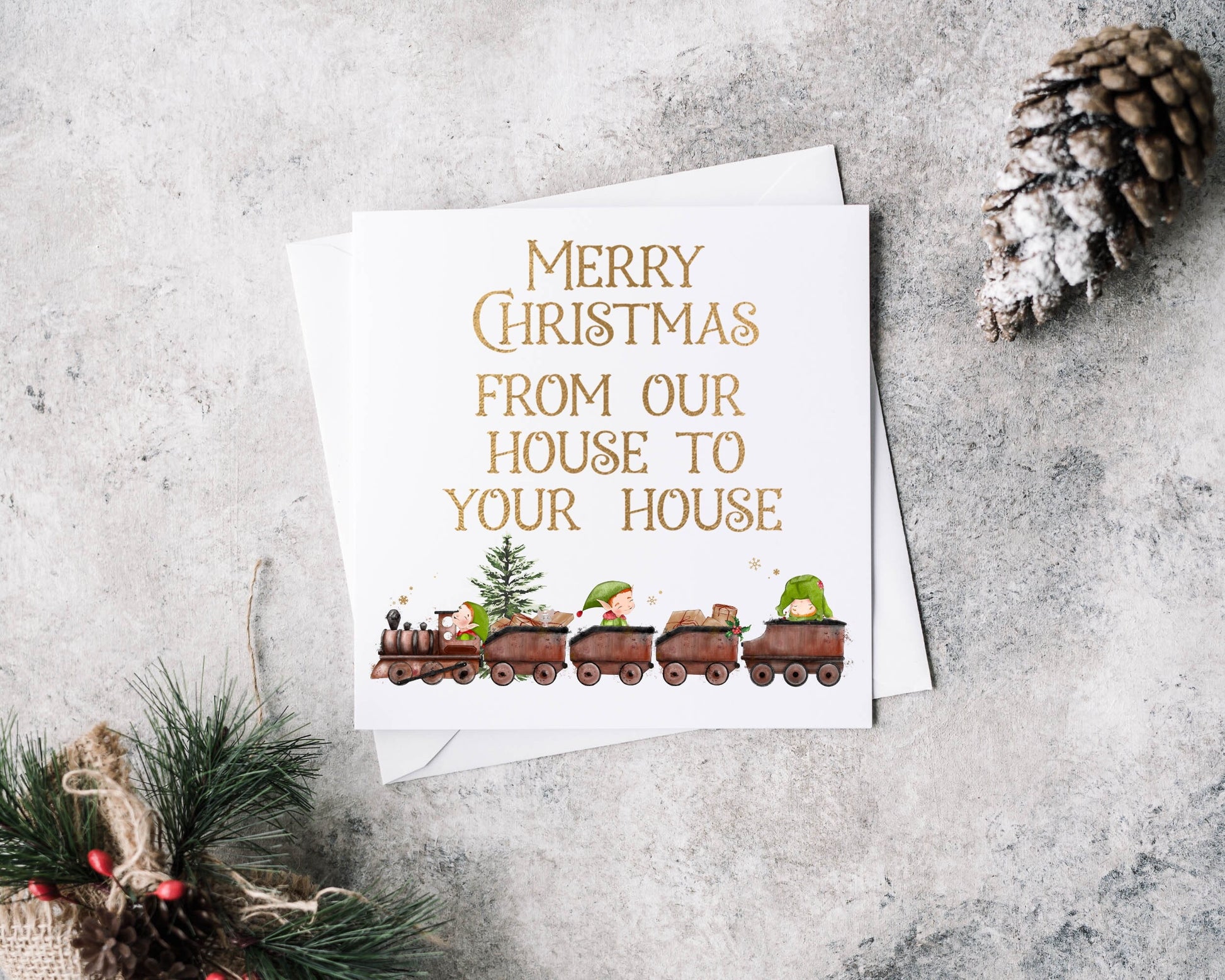 Christmas card with an elf train design and text reading 'Merry Christmas from our house to your house'