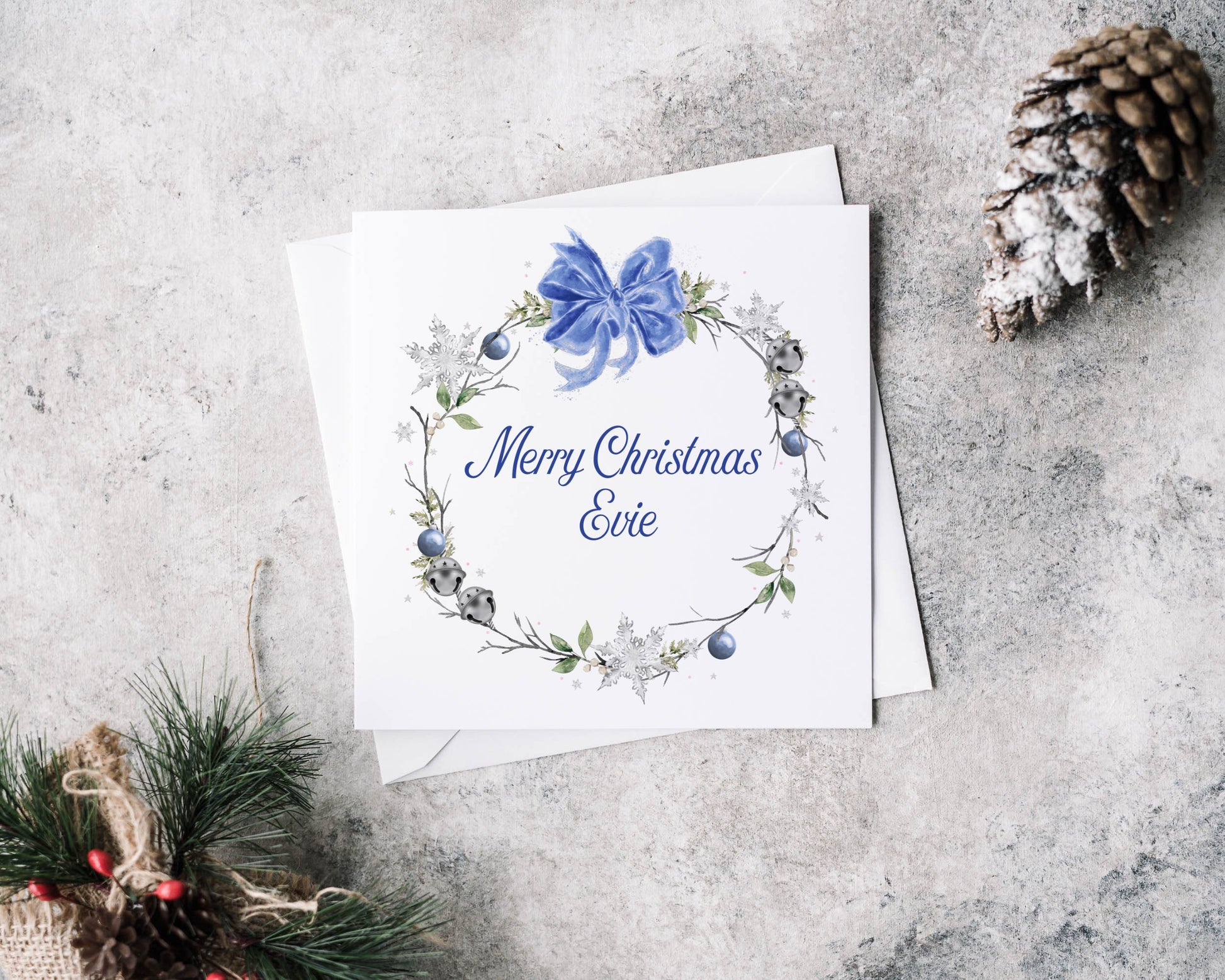 Christmas greeting card featuring a winter blue wreath and personalised text