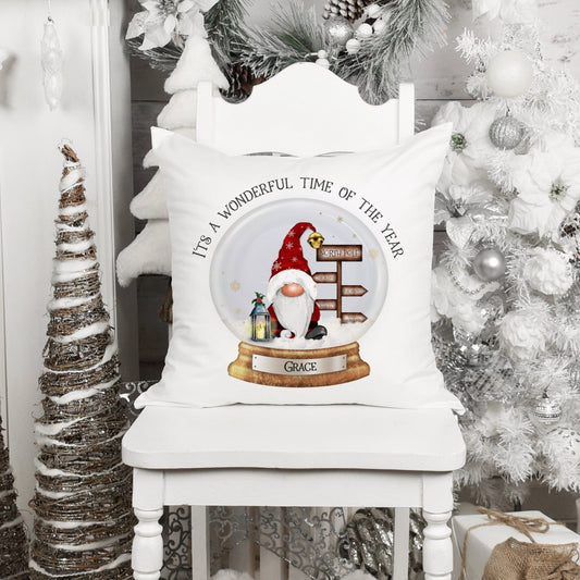 Square cushion featuring a santa with a sign post and a lantern in a snowglobe. The text reads 'It's a wonderful time of the year' Can be personalised