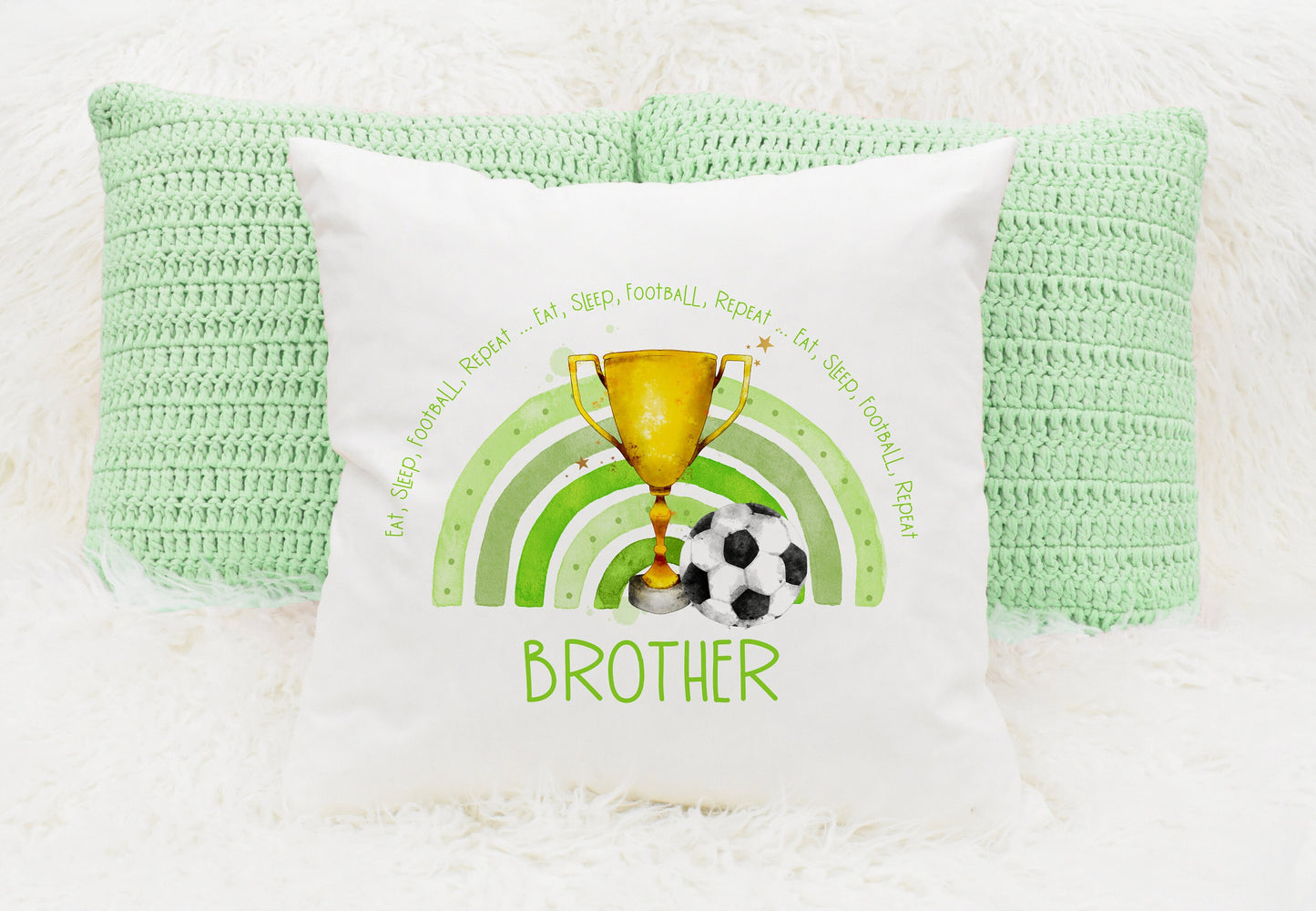 Square cushion featuring a green rainbow, a trophy and a football. The text reads 'eat, sleep, football, repeat...' Can be personalised