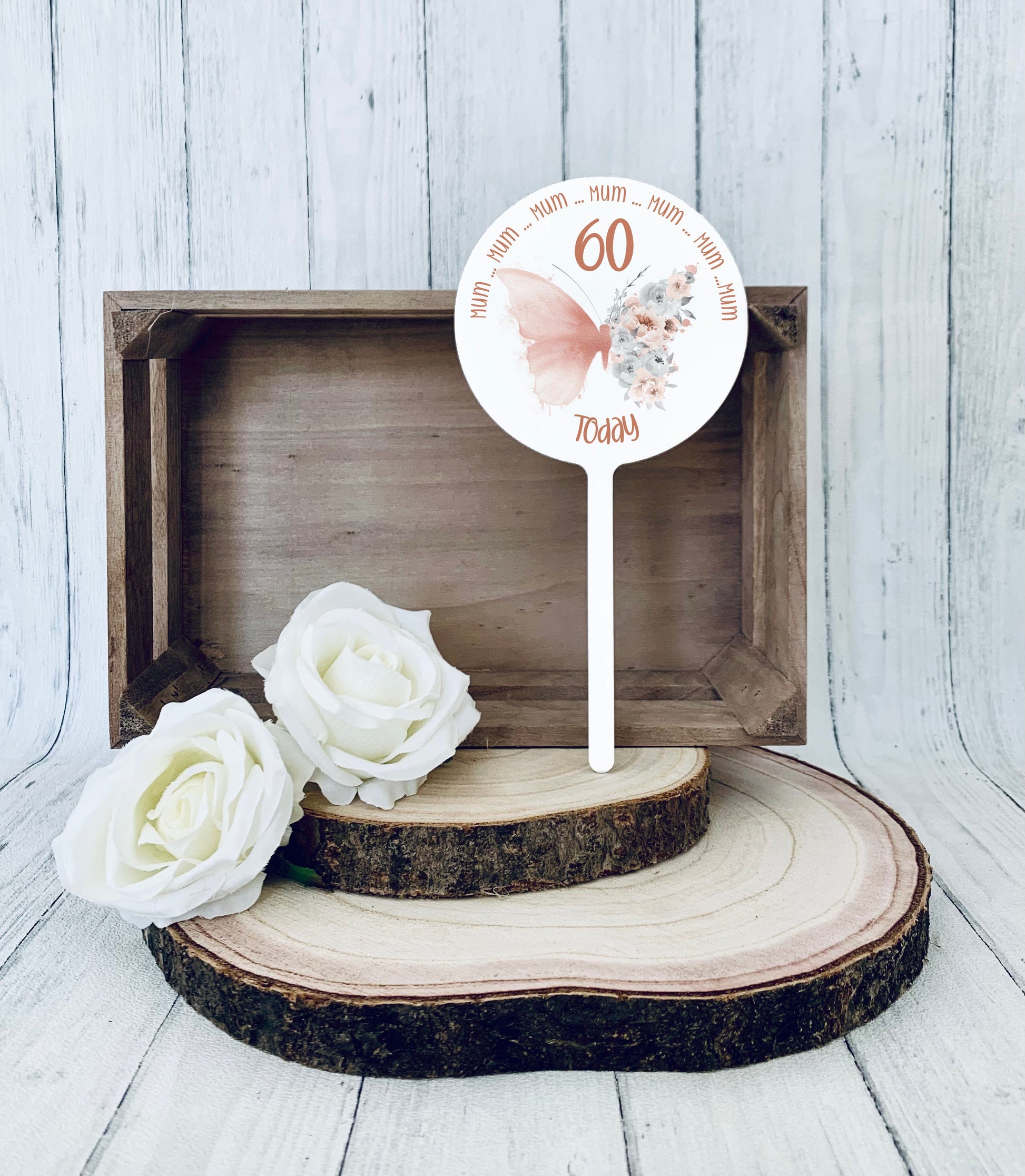 Acrylic round cake topper featuring  a rose gold floral butterfly with personalised birthday text
