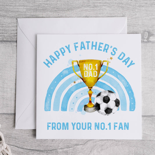 Father's day greeting card, the design features a trophy, a blue rainbow and a football, text reads 'Happy Father's Day from your no.1 fan'
