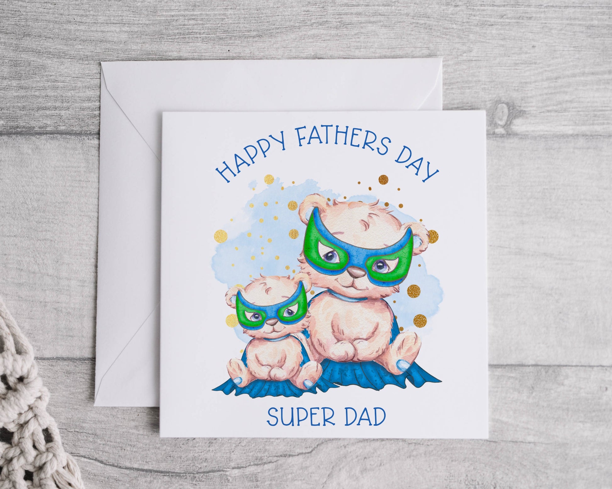 Father's Day greeting card featuring a dad and baby bear in capes and masks.  The text reads 'Happy Father's Day Super Dad'