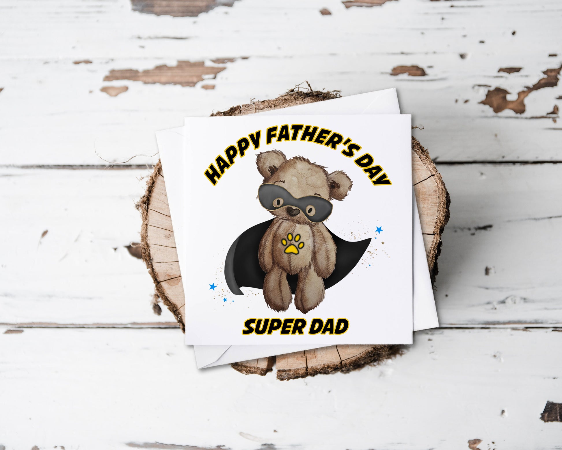 Square greeting card featuring a teddy bear wearing a black cape and a black eye mask design. The text reads 'Happy Father's Day Super Dad'