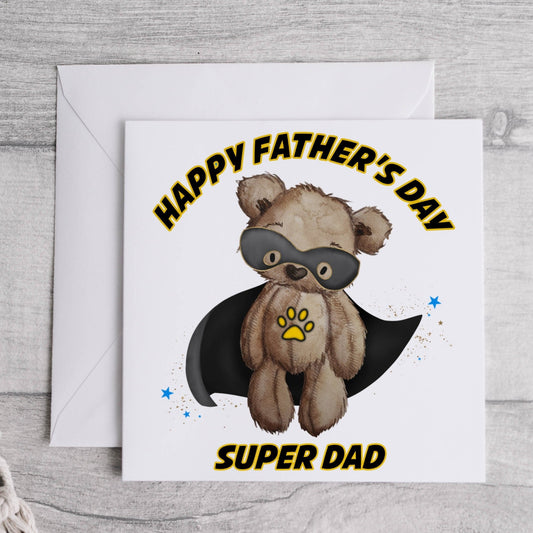 Square greeting card featuring a teddy bear wearing a black cape and a black eye mask design. The text reads 'Happy Father's Day Super Dad'
