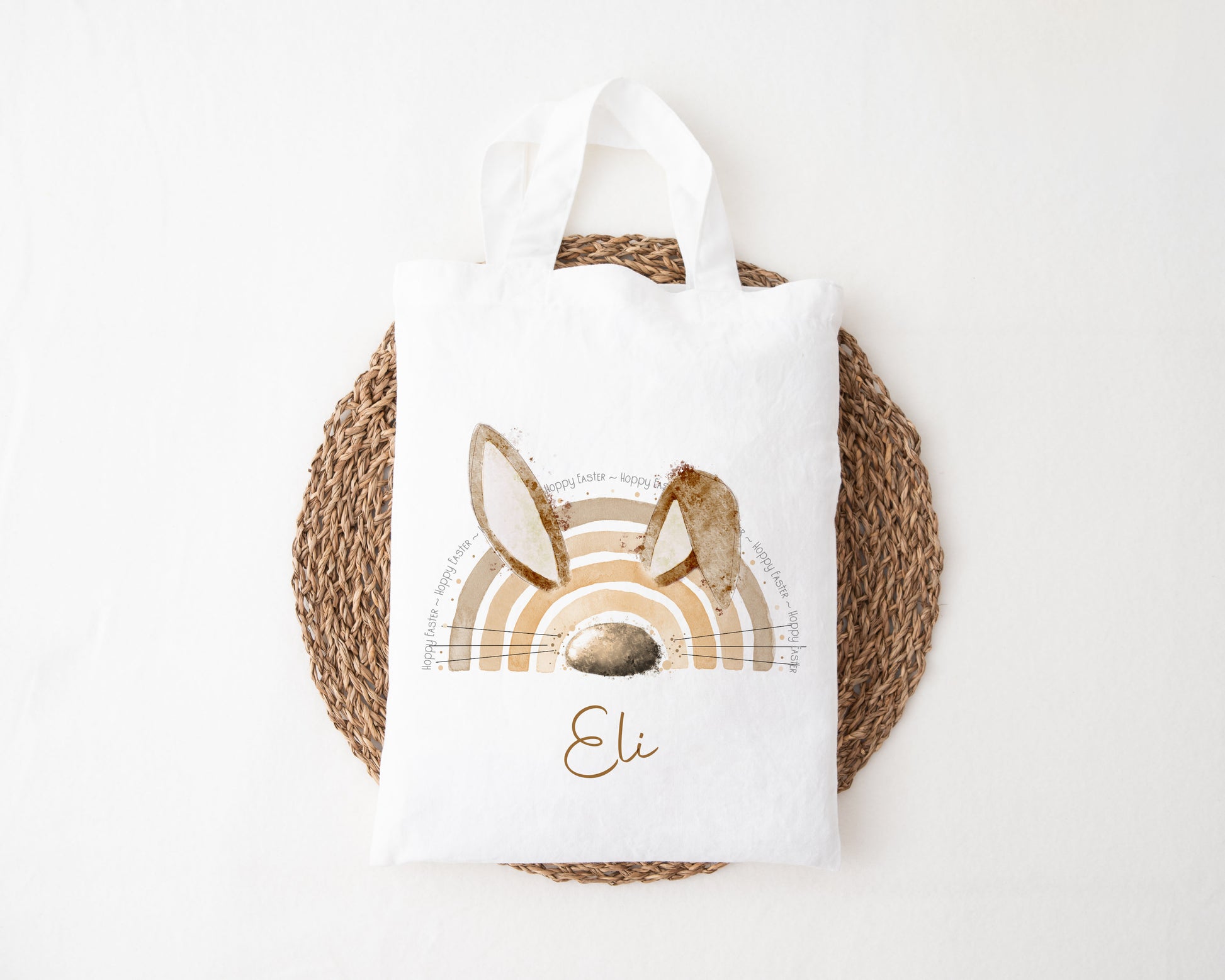 Easter egg hunt mini tote bag featuring a bunny ear rainbow in brown and is personalised