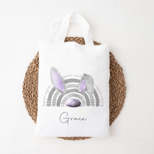 A mini tote bag featuring a personalised lilac rainbow bunny ear design.