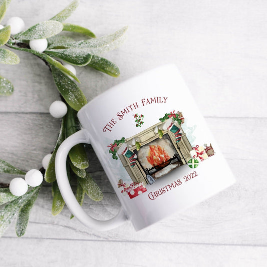 Ceramic mug featuring a traditional fireplace, green and red stockings, cute mice and wrapped gifts with personalised text