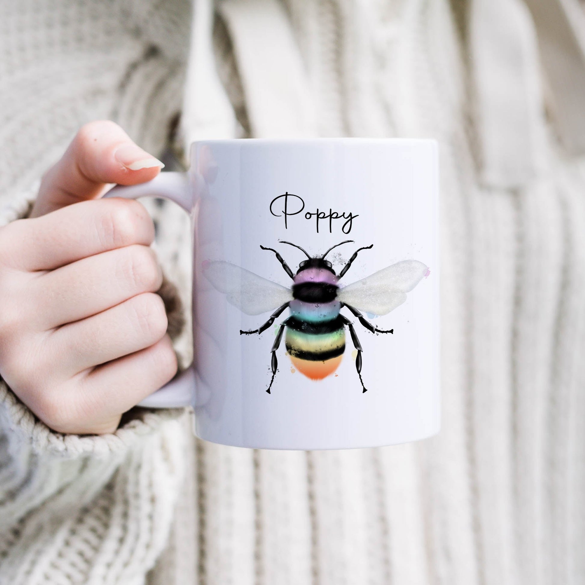 Ceramic mug with the design of a rainbow coloured bumble bee and can be personalised