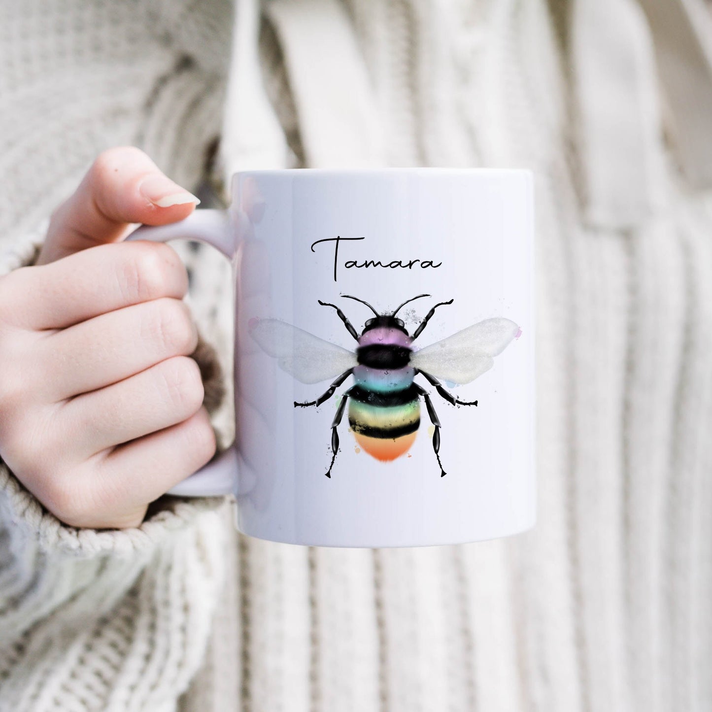 Ceramic mug with the design of a rainbow coloured bumble bee and can be personalised