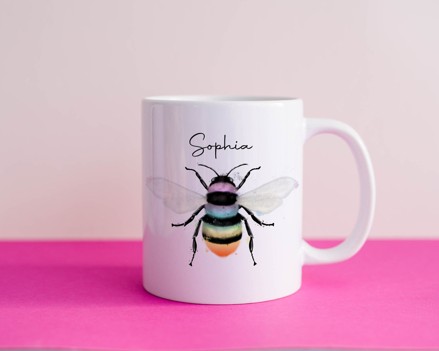 Ceramic mug with the design of a rainbow coloured bumble bee and can be personalised