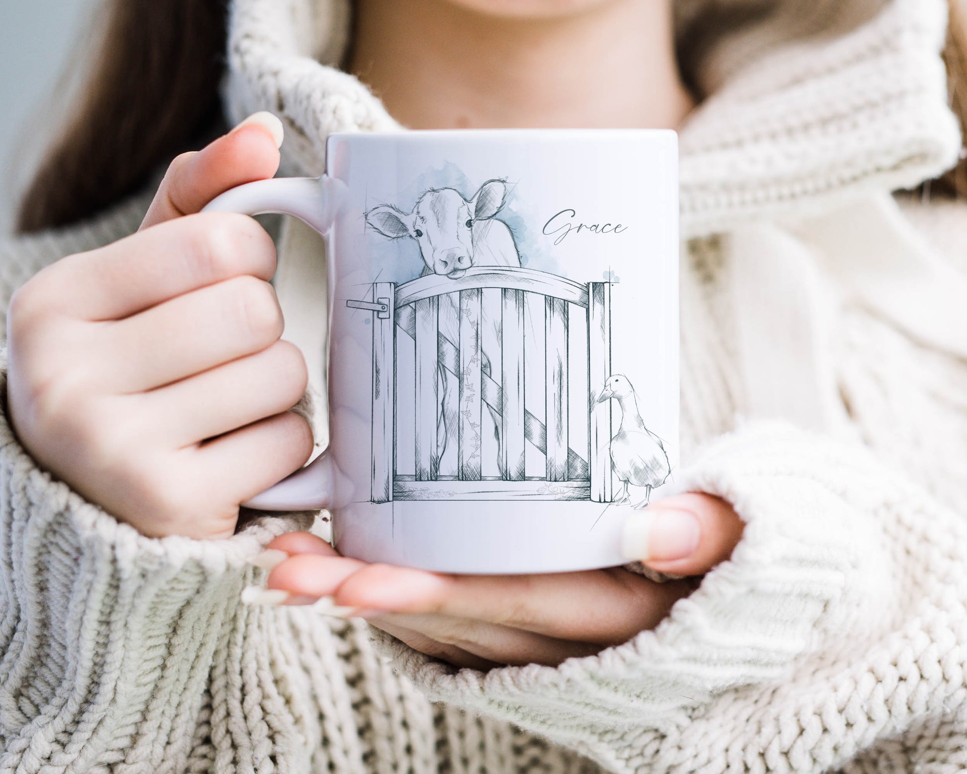 Personalised ceramic mug with a sketched image of a cow and a duck standing at a gate